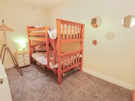 A bedroom with a bunk bed and a lamp at 20 Lorton Street in Cockermouth