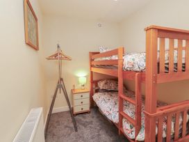 A bedroom with a bunk bed and a lamp at 20 Lorton Street Cockermouth