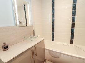 A bathroom with a bathtub and sink at 20 Lorton Street Cockermouth