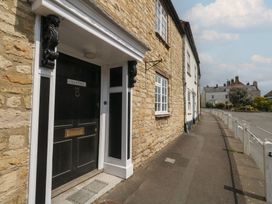 An entrance with a door and stone wall at Crantock