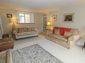 A living room with a sofa and armchair at Crantock