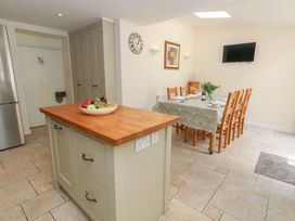 A kitchen with an island and dining area at Crantock