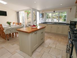 A kitchen with a dining area and appliances at Crantock