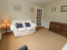 A living room with a sofa and side table at Crantock