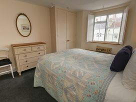 A bedroom with a bed and chest of drawers at Crantock
