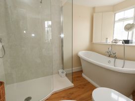 A bathroom with a shower and bathtub at Crantock