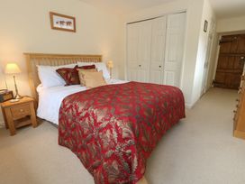 A bedroom with a bed and bedside table at Crantock