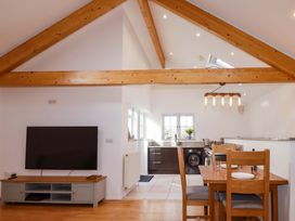 A kitchen and dining area with a table and chairs at The Maisonette in Hayle