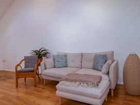 A living room with a sofa and a chair at The Maisonette in Hayle