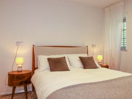 A bedroom with a bed and bedside tables at The Maisonette in Hayle