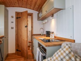 A kitchen with wooden countertops and kitchen sink at Dave’s Place Broadstone near Munslow