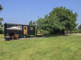 A cabin with a patio and furniture in an outdoor area at Dave’s Place Broadstone near Munslow