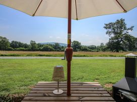 An outdoor area with an umbrella and a lamp at Dave’s Place Broadstone near Munslow