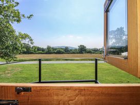 A view of grass and trees from a window at Dave’s Place in Broadstone near Munslow