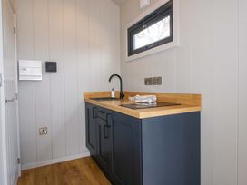 A kitchen with a sink and countertop at Leafy Oak Lodge in Munslow