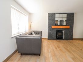 A living room with a sofa and fireplace at Bigting in Rhosneigr