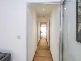 A hallway with doors on either side at Bigting in Rhosneigr