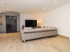 A living room with a sofa and television at Bigting in Rhosneigr