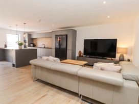 A living room with a sofa and television at Bigting in Rhosneigr