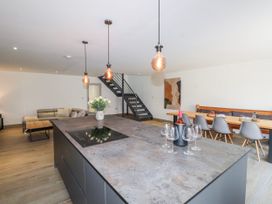 A kitchen with an island and dining area at Bigting in Rhosneigr