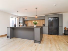 A kitchen with an island and modern appliances at Bigting in Rhosneigr