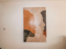 A wall art depicting abstract faces at Bigting in Rhosneigr