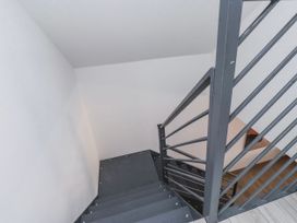 A staircase with a handrail at Bigting in Rhosneigr