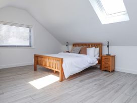 A bedroom with a bed and nightstand at Bigting in Rhosneigr