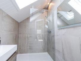 A bathroom with a shower and sink at Bigting in Rhosneigr