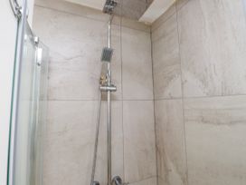 A shower with a showerhead and handheld shower at Bigting in Rhosneigr