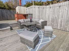 An outdoor patio with a seating area at Bigting in Rhosneigr