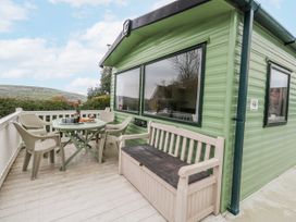 An outdoor area with a table and chairs at Swanage Coastal Park Caravan in Swanage