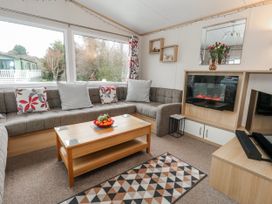 A living room with a sofa arrangement and coffee table at Swanage Coastal Park Caravan in Swanage