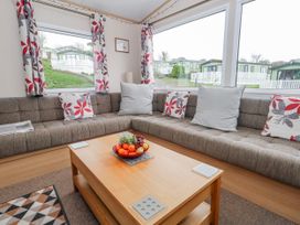 A living room with a sofa and coffee table at Swanage Coastal Park Caravan in Swanage