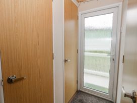 An entrance area with doors and a glass door at Swanage Coastal Park Caravan in Swanage