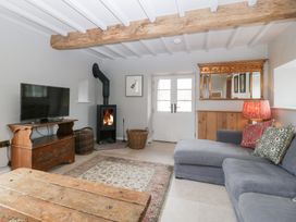 A living room with a television and a sofa at Velindra Farm Cottage in Hereford