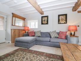 A living room with a sofa and coffee table at Velindra Farm Cottage Hereford