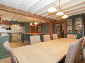 A kitchen with a dining table and chairs at Velindra Farm Cottage in Hereford