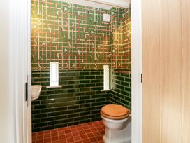 A bathroom with a toilet and sink at Velindra Farm Cottage Hereford