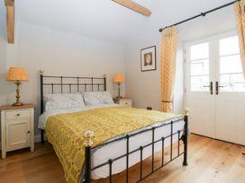 A bedroom with a bed and nightstands at Velindra Farm Cottage Hereford