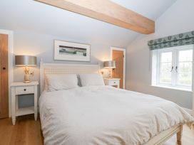 A bedroom with a bed and lamps at Velindra Farm Cottage Hereford