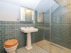 A bathroom with a sink and shower at Velindra Farm Cottage Hereford