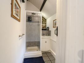 A bathroom with a shower and sink at Fullers Studio Caergeiliog