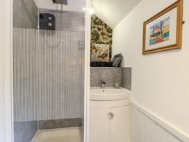 A bathroom with shower and sink at Fullers Studio in Caergeiliog