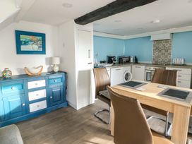 A kitchen with table and chairs at The Mill in Holyhead