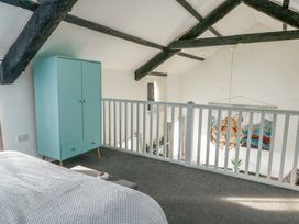 A bedroom with a wardrobe and railing at The Mill in Holyhead