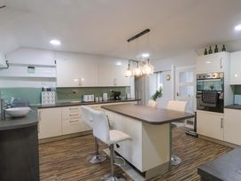 A kitchen with an island and appliances at Ty Crigyll in Holyhead
