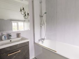 A bathroom with a bathtub and a sink at Ty Crigyll in Holyhead