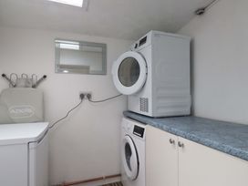 A laundry room with washer and dryer at Ty Crigyll, Holyhead