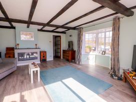 A living room with a sofa and a fireplace at Ty Crigyll in Caergeiliog